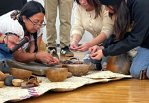 Culture, connection, and cacao: Día de los Muertos celebration at SLCC Esmeralda showing the process of cleaning cacao beans to volunteers