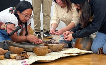 Culture, connection, and cacao: Día de los Muertos celebration at SLCC Esmeralda showing the process of cleaning cacao beans to volunteers