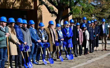 Groundbreaking: A new business building is coming to SLCC A row of dignitaries wearing blue hard hats and holding blue shovels