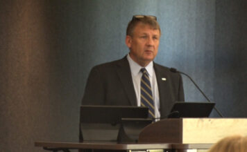 Salt Lake Community College hosts informative session on Utah’s legislative process Scott E. Brown speaking from a lectern