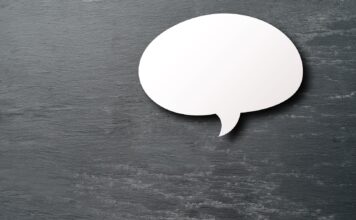 Letter from the editor: An apology to the community White speech bubble on a silver background