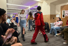 Designing fashion for the future at Salt Lake Community College Fashion models walking through the hallway in front of an audience