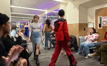 Designing fashion for the future at Salt Lake Community College Fashion models walking through the hallway in front of an audience
