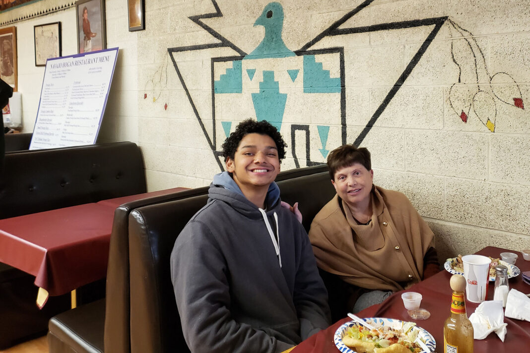 Julie Slack, right, and her son Noah, seated at a restaurant booth