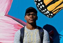 SLCC Hometowns: Jevah France Jevah standing in front of the Peace and Justice Garden mural