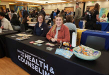 SLCC health center to host ‘Spread Love, Not STIs’ event Peggy Fisher, left, and Madison Gregory sitting at a table for the Center for Health and Counseling