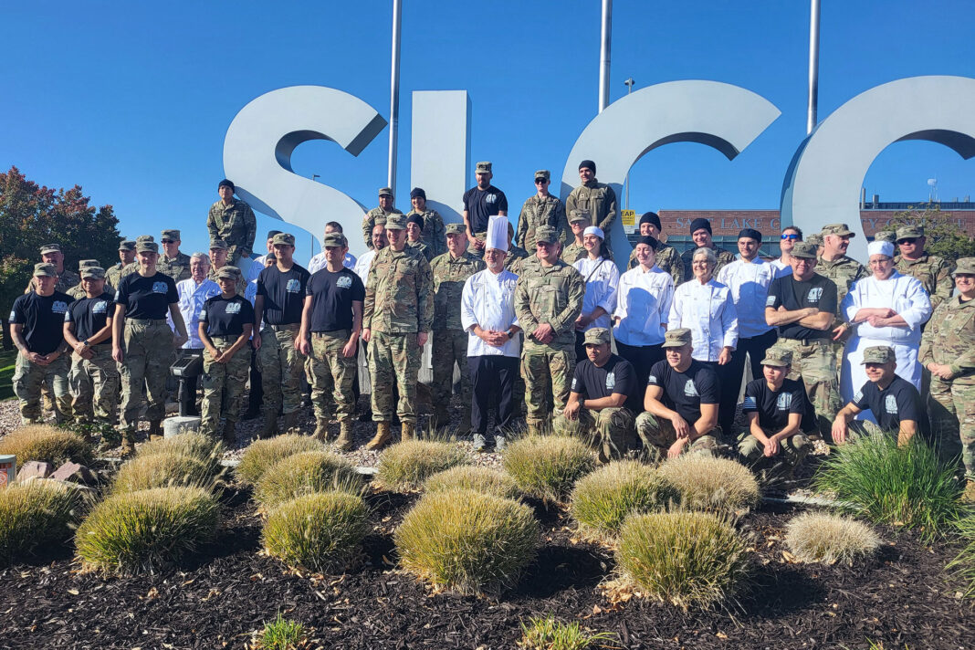 A group photo of student chefs, faculty and military personnel