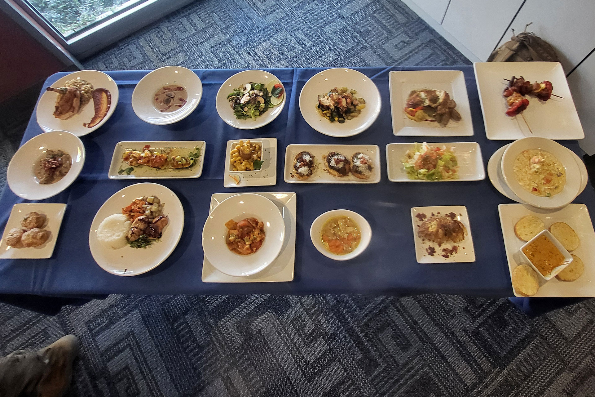 Plates of various food courses displayed on a table