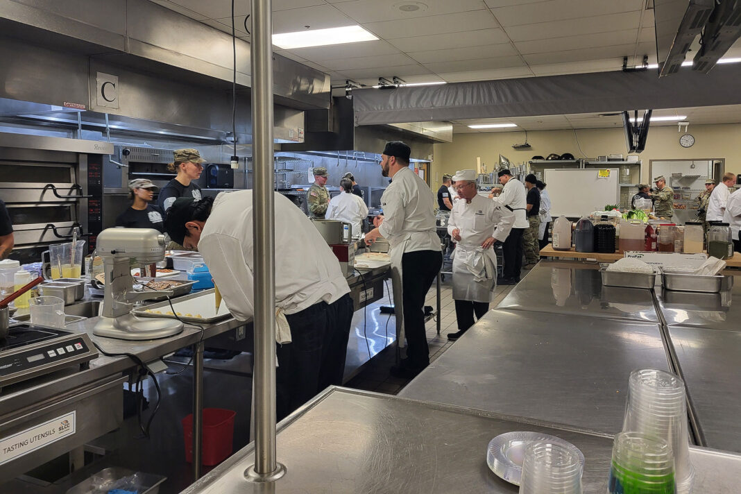 Student chefs and Guard members working in a culinary kitchen