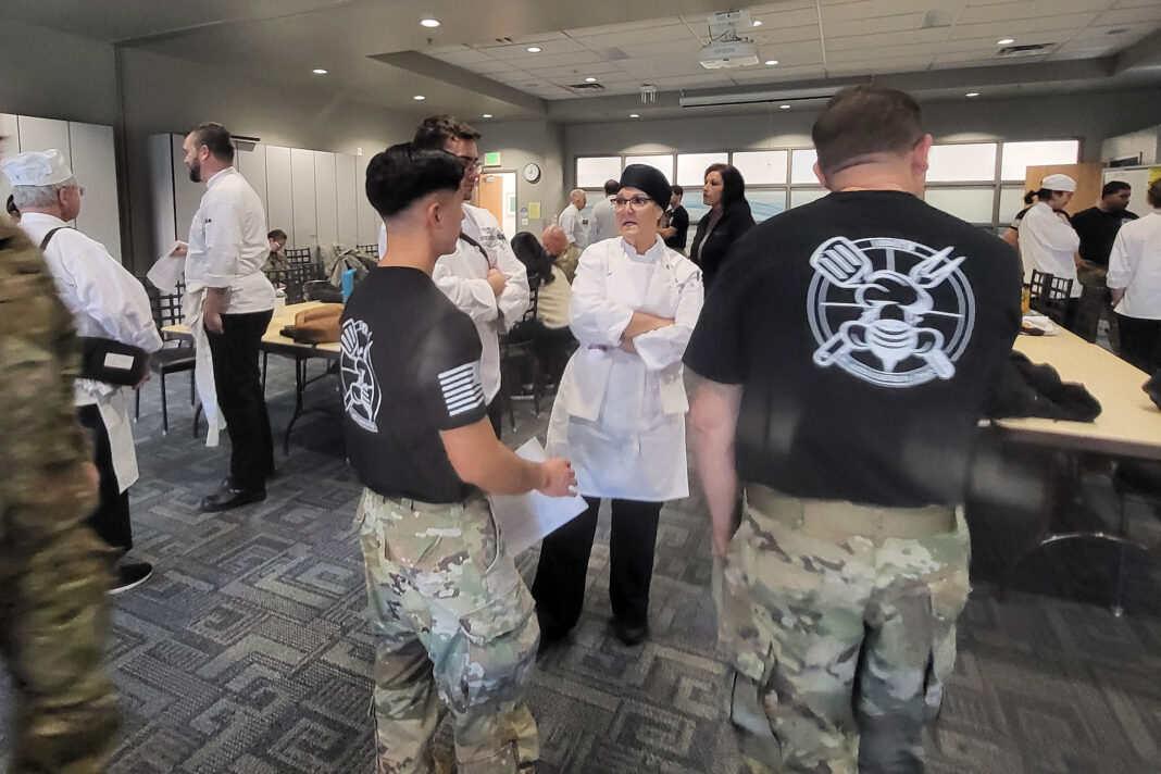 SLCC student chefs discussing culinary plans with National Guard members