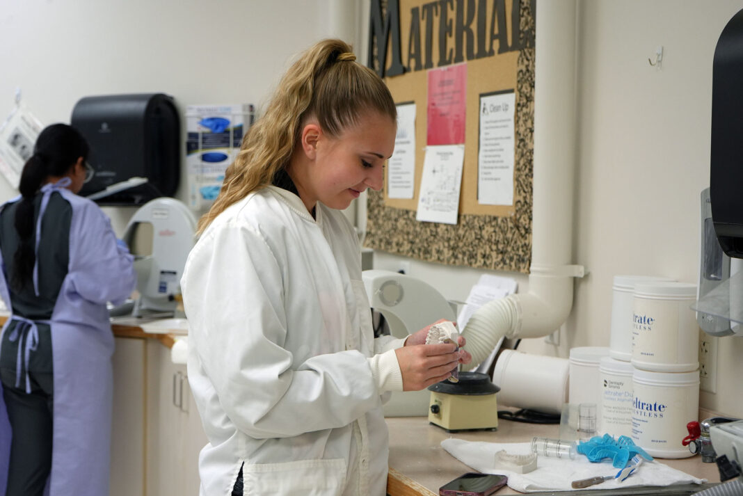 Dental hygiene student working in a lab
