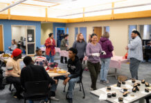Students learn art, science of candle making Group of people making candles in a large meeting room