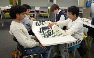 SLCC Chess Club: making friends and mastering life skills, one move at a time Two pairs of students playing chess
