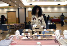Pop-up market showcases local Black entrepreneurs African American woman standing behind a table displaying her handmade goods