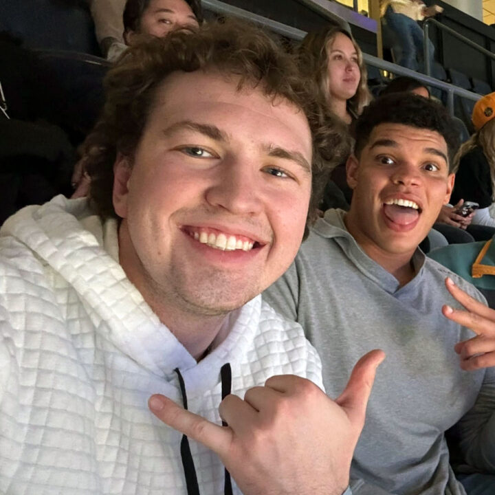 Two fans attending a basketball game