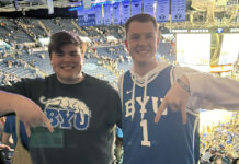 From wild upsets to championship dreams: SLCC talks March Madness Two fans giving the "Hook'em Horns" sign upside down