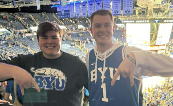 From wild upsets to championship dreams: SLCC talks March Madness Two fans giving the "Hook'em Horns" sign upside down
