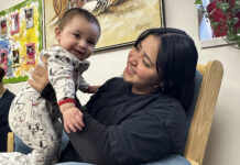 Postpartum depression: a hidden struggle in Latin communities Mother holding her baby while seated in a chair