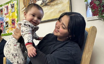 Postpartum depression: a hidden struggle in Latin communities Mother holding her baby while seated in a chair