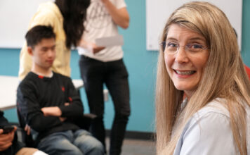 SLCC professor Penny Bivens shares her journey for Women’s History Month Penny Bivens headshot with other people blurred in the background