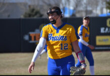 From the mound to mentorship: Taylor Hagen’s softball journey Taylor Hagen wearing a face guard while pitching
