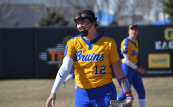 From the mound to mentorship: Taylor Hagen’s softball journey Taylor Hagen wearing a face guard while pitching
