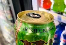 How students use caffeine to power through the semester’s final stretch Person holding a bright green can of Monster Irish Creme energy drink