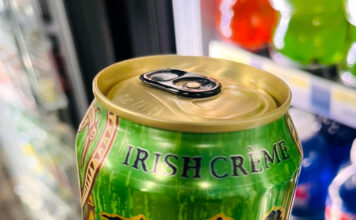 How students use caffeine to power through the semester’s final stretch Person holding a bright green can of Monster Irish Creme energy drink