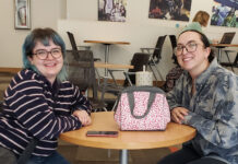 Federal cuts to PBS, NPR cause concern in the SLCC community Hannah and Janaye seated at a table in the forum