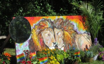 Pride in full bloom: Artists explore identity and belonging at Red Butte Garden Mural depicting two male lions surrounded by rainbow flags