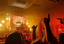 Staff roundup: summer concerts Crowd raising hands to cheer for band on stage