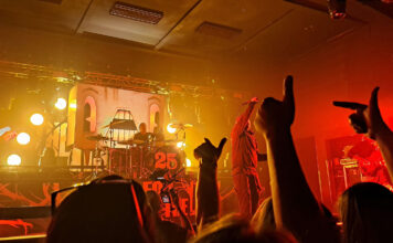 Staff roundup: summer concerts Crowd raising hands to cheer for band on stage