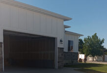 SLCC students build a new home in West Jordan View from sidewalk of a new home with an open garage door