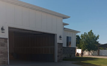 SLCC students build a new home in West Jordan View from sidewalk of a new home with an open garage door