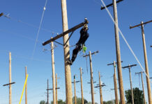SLTech program graduates celebrate with a lineworker’s rodeo Lineworker moving a pin insulator while on a power pole