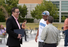 A new era for SLCC sports: Athletic director details plans of innovation, inclusion, and impact Coaches and administrators talking outside in a courtyard