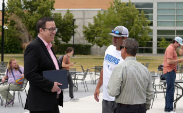 A new era for SLCC sports: Athletic director details plans of innovation, inclusion, and impact Coaches and administrators talking outside in a courtyard