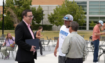 A new era for SLCC sports: Athletic director details plans of innovation, inclusion, and impact Coaches and administrators talking outside in a courtyard