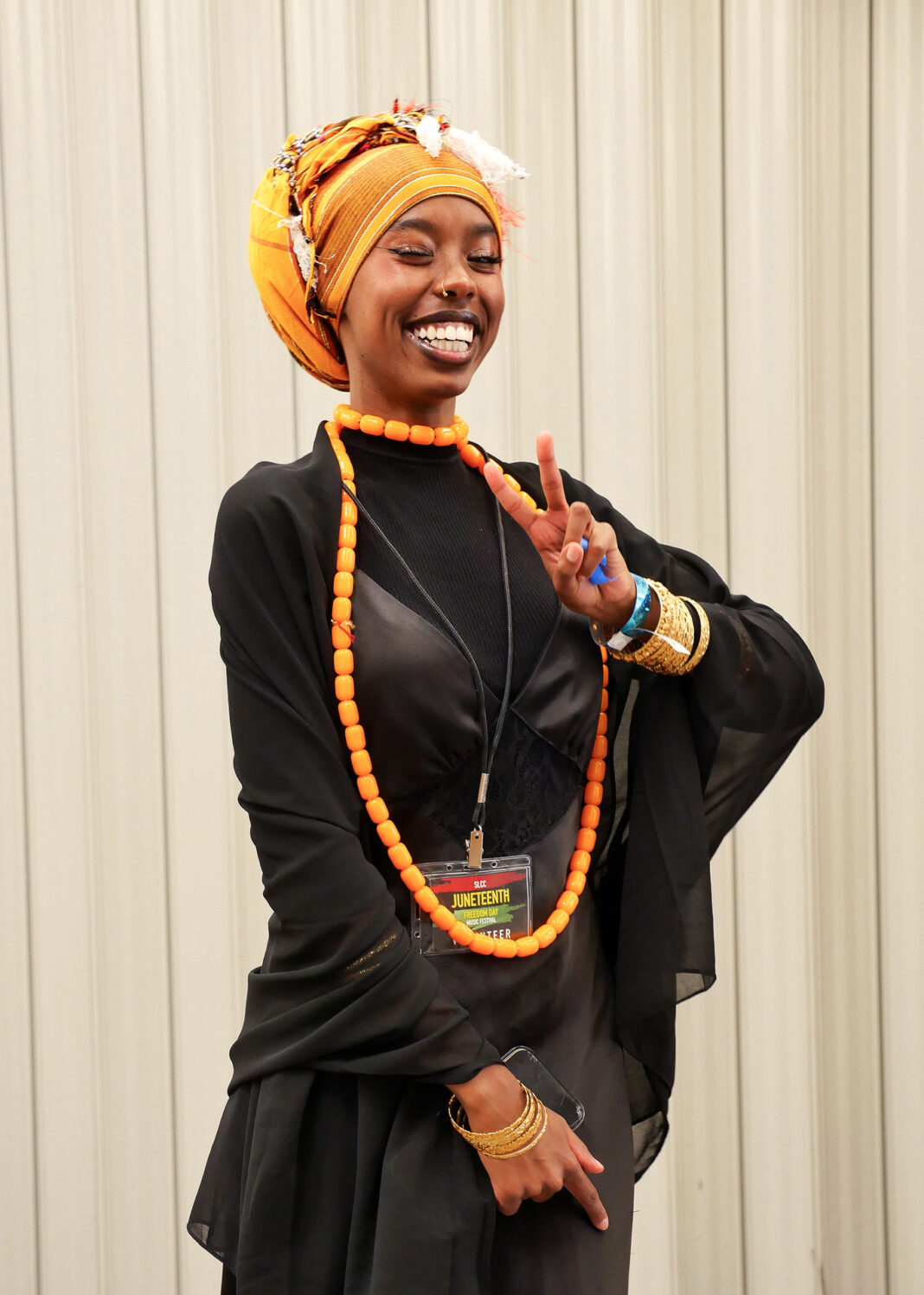 Tashelle Wright smiling and giving the "V" hand symbol