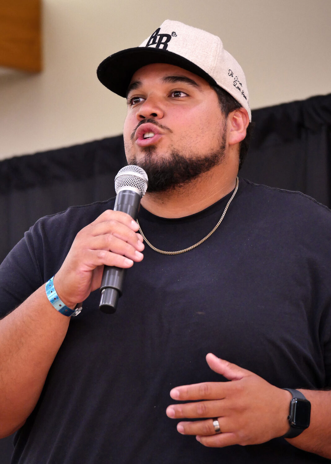 Hakim Abdul-Rahman talking into a microphone