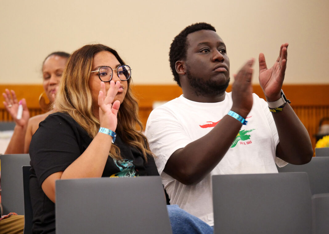 Aniska and Ezra Malik following along with a performance