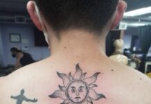 The art of tattoos and the stories students carry Photo of a man's neck and shoulders with a tattoo of a sun and a man standing on Earth