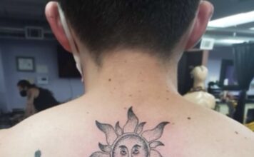 The art of tattoos and the stories students carry Photo of a man's neck and shoulders with a tattoo of a sun and a man standing on Earth