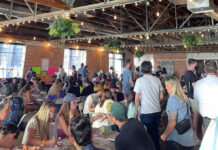 Our voices matter: Writing our way to change Large crowd gathering inside a coffee shop