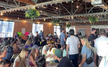Our voices matter: Writing our way to change Large crowd gathering inside a coffee shop