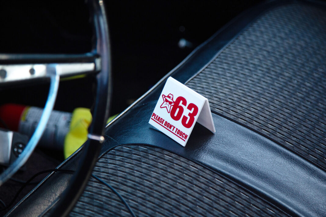 White folded placard with number 63 placed on a car seat