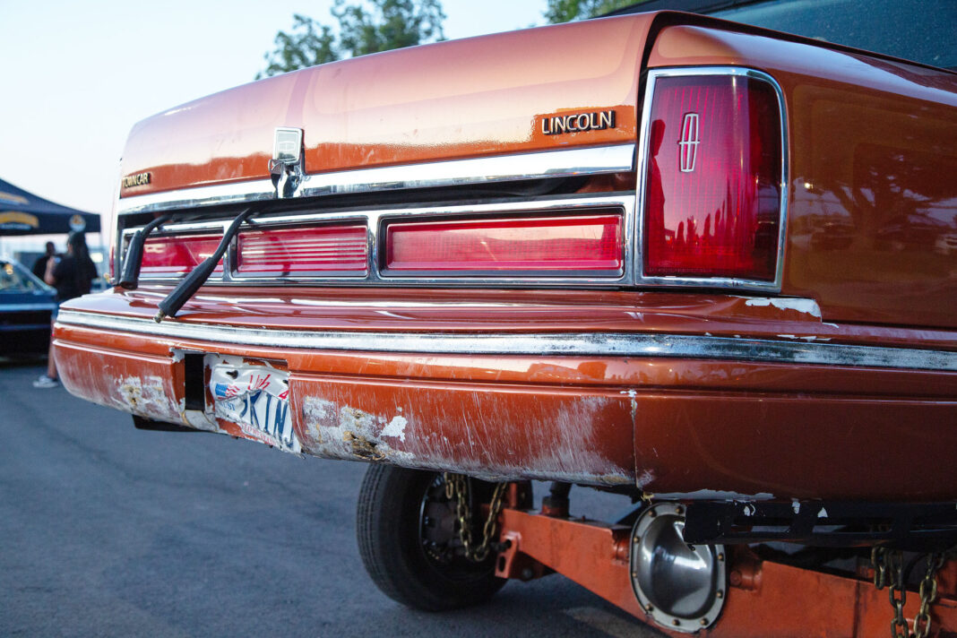 Damage to rear bumper of orange Lincoln lowrider