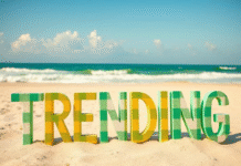 Summer trends: Fashion, food, music — oh, my! the word "TRENDING" written in yellow and green plaid pattern letters displayed on a beach