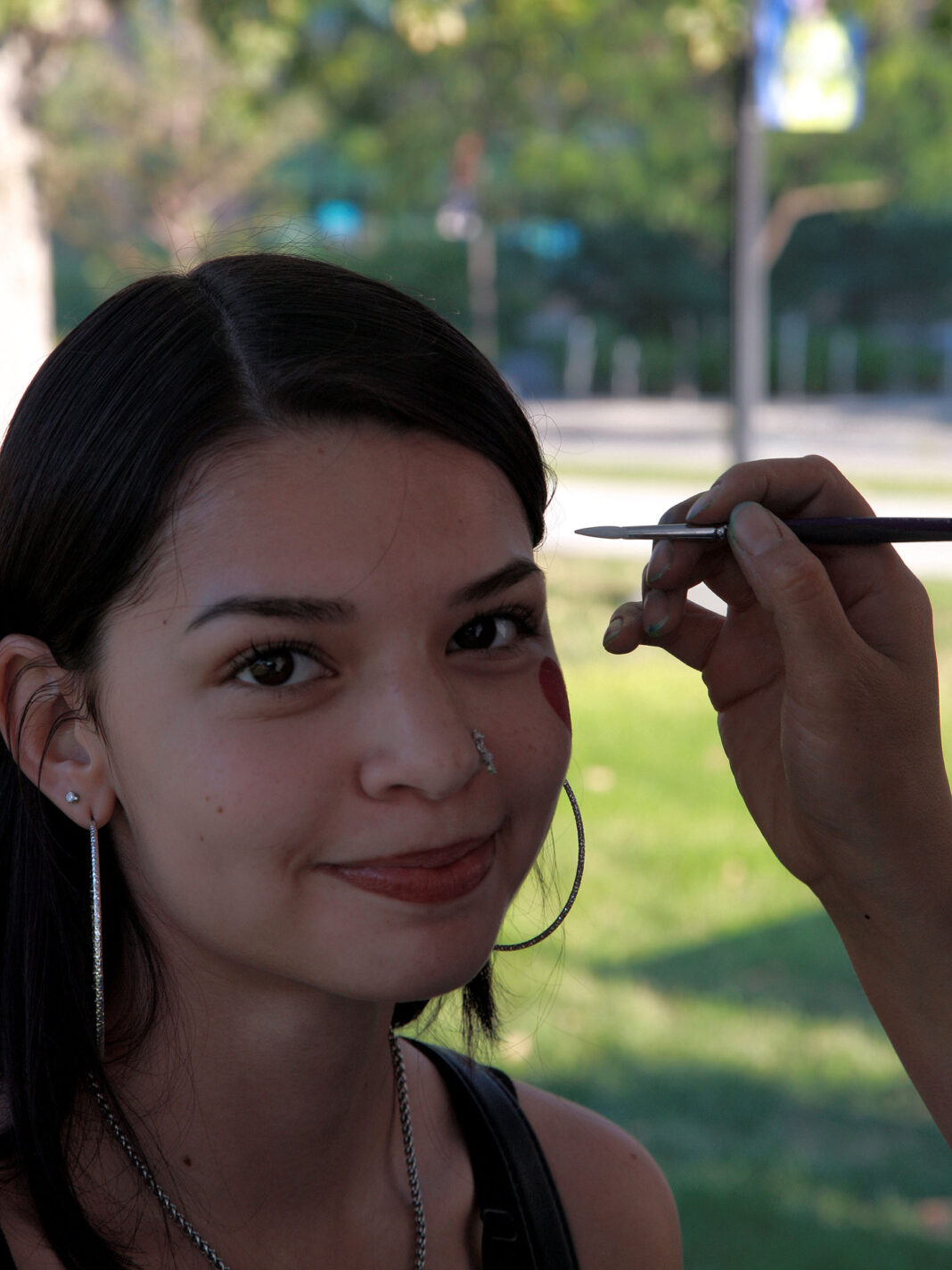Makayla smiling while getting her face painted