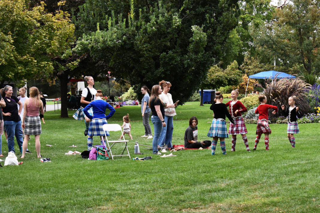 Children and their parents standing together outside